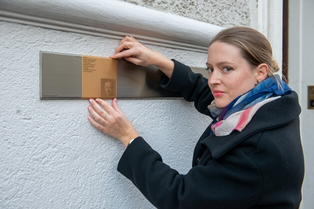 Isabell Gruber with the Memorial Sign for Prof Dr August Liebmann Mayer